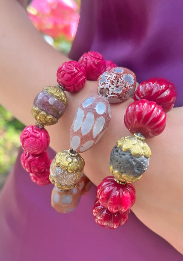 Barbie inspired jewelry by Devon Leigh. Photo of pink authentic healing gemstone beaded bracelets layered together for the perfect pink bohemian barbie style. 