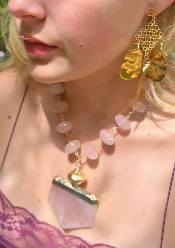 Beautiful handmade bohemian statement jewelry featuring a rose quartz pendant necklace and hammered gold chandelier earrings. Handmade in Los Angeles  