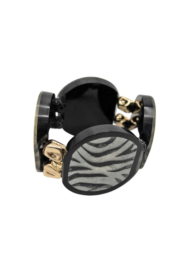 Discover this luxe statement bracelet featuring bold black and white zebra print resin slabs, accented with 18k gold plated beads. A creative and unique statement bracelet, handmade in Los Angles, California.