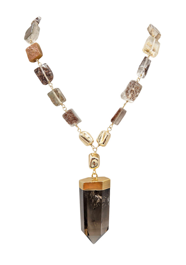 Designed for the bohemian at heart, this Smoky Quartz & Raw Tourmaline Pendant Necklace is one of a kind and handmade in the USA. The ethically sourced stones represent healing, spirituality and love. Gold and raw stone necklace featuring a smokey quartz pendant.