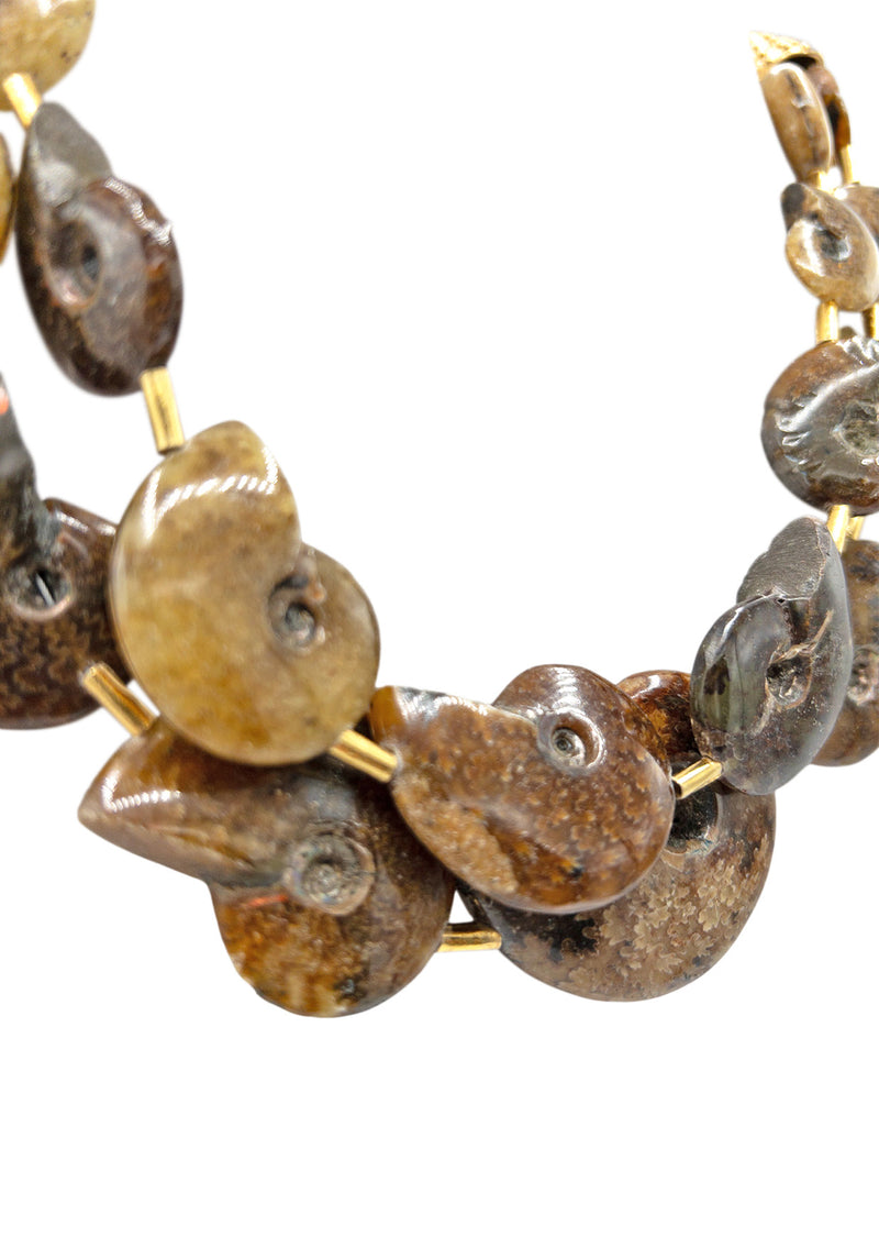 Like nothing you've ever seen, this one-of-a-kind fossilized ammonite multi-strand necklace was designed to bring ancient energy into your everyday styling. The varying browns and deep neutrals make this ultra bohemian statement necklace perfect for fall styling.