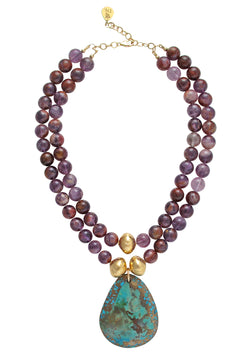 One of a kind bohemian chic necklace handcrafted by luxury jewelry designer Devon Leigh. This stunning Natural Super Seven Turquoise Pendant Necklace is a show-stopping statement piece. Crafted with Natural Super Seven beads, a gold accent, and an oversized Turquoise Pendant, this jaw-dropping necklace was designed to make a statement. 